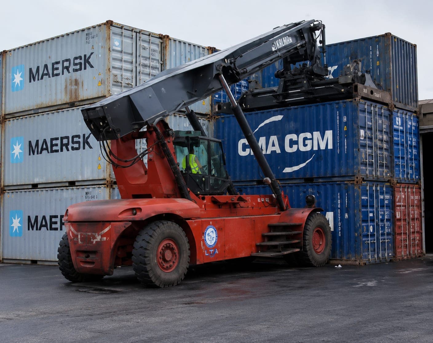 Chariot cavalier saisissant un conteneur maritime